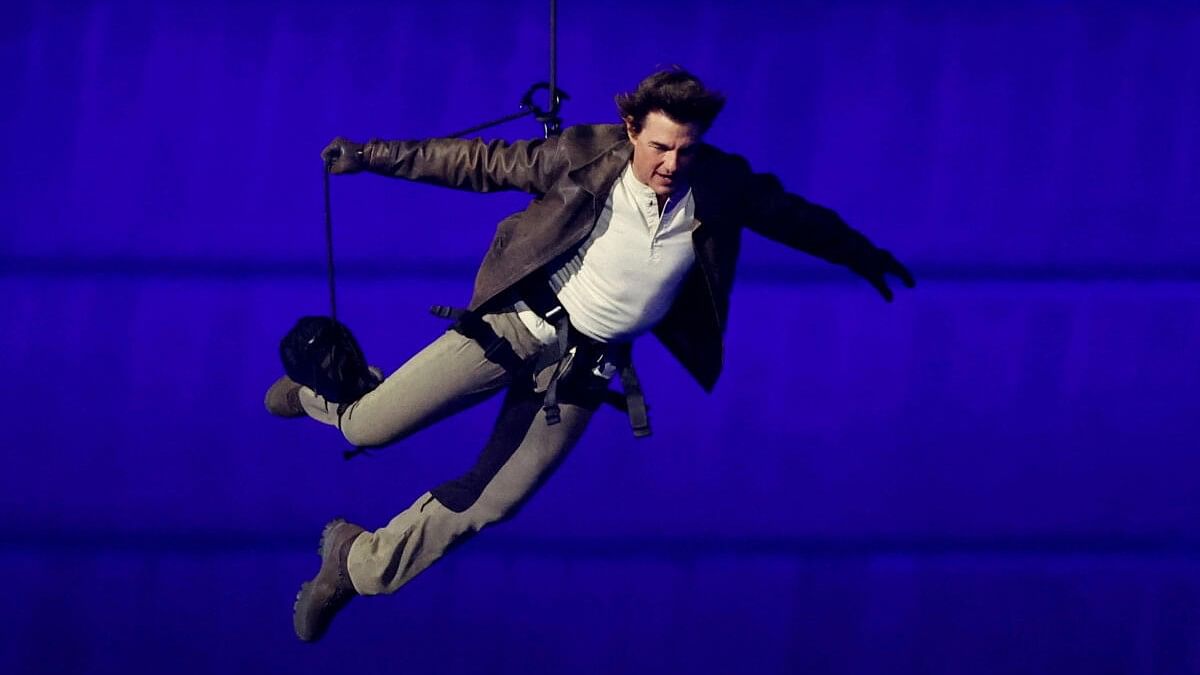 <div class="paragraphs"><p>Actor Tom Cruise jumps from the roof of the Stade de France during the Olympics closing ceremony.</p></div>