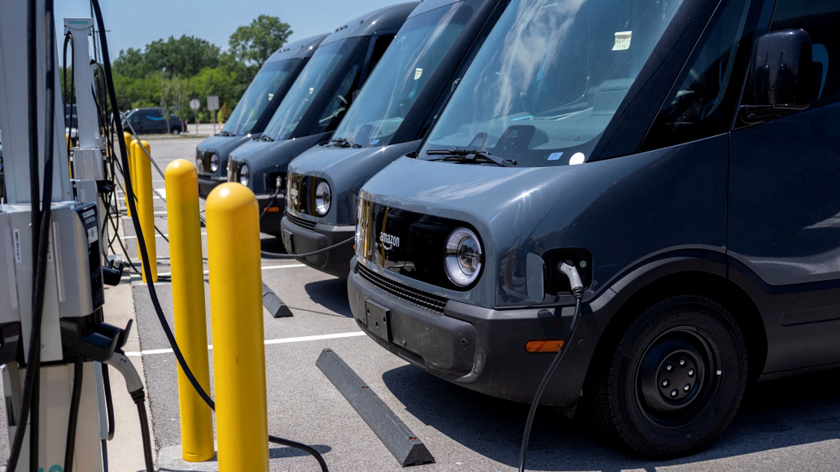 <div class="paragraphs"><p>New Amazon EV vans parked, powered at an Amazon Logistics Facility.</p></div>