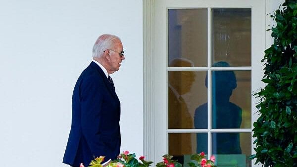 <div class="paragraphs"><p>US President Joe Biden walks to the Oval Office from Marine One as he returns to the White House on August 12</p></div>