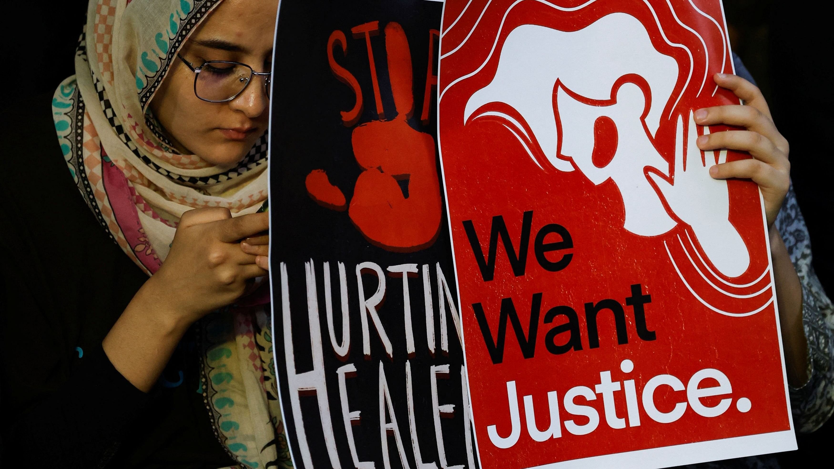 <div class="paragraphs"><p>Medical students hold posters as they attend a protest against what they say was rape and murder of a trainee doctor, inside the premises of R G Kar Medical College and Hospital in Kolkata,&nbsp;India, August 13, 2024. </p></div>