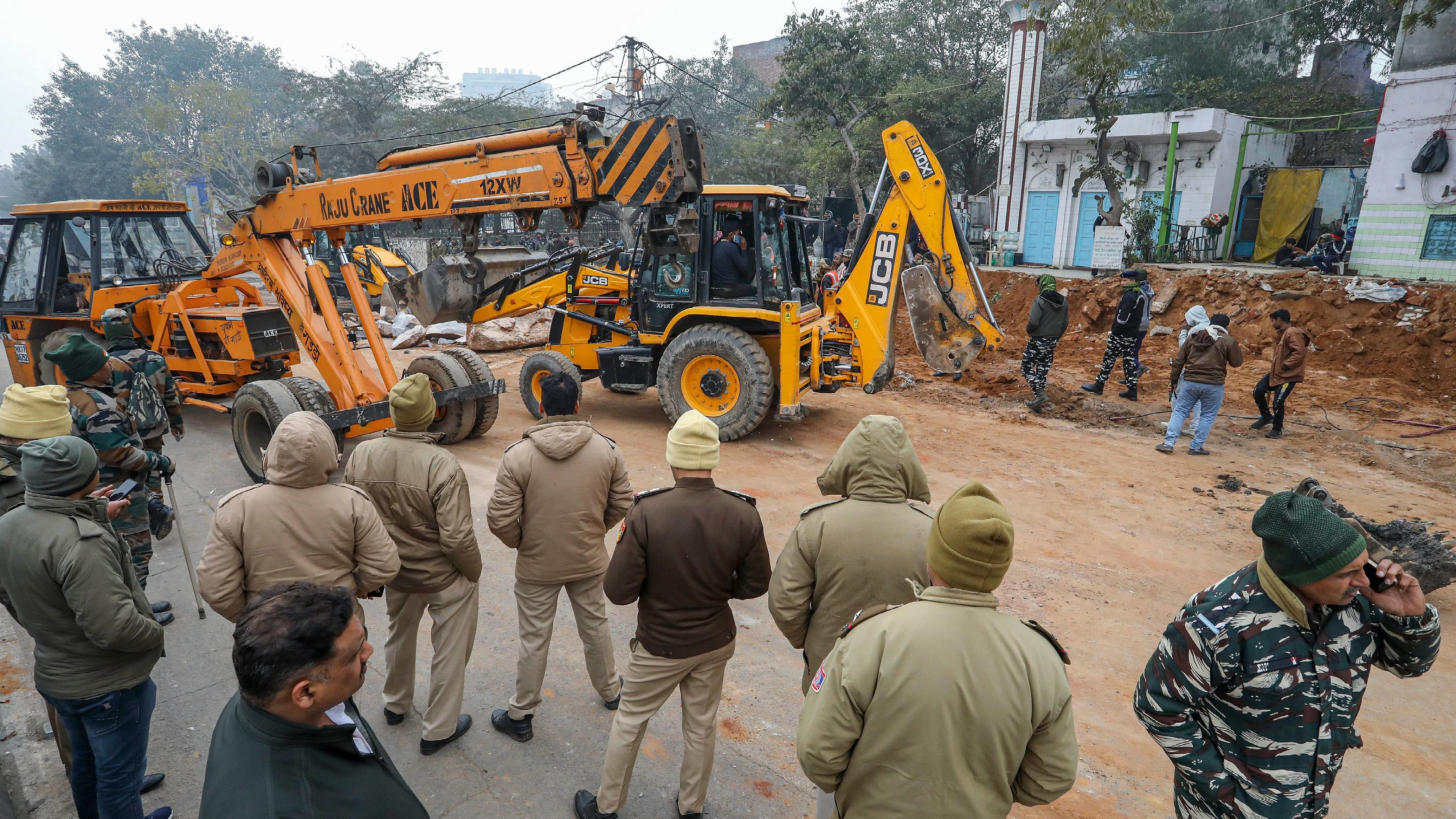 <div class="paragraphs"><p>Representative image showing Police personnel standing guard as MCD carries out demolition drive in Delhi. </p></div>