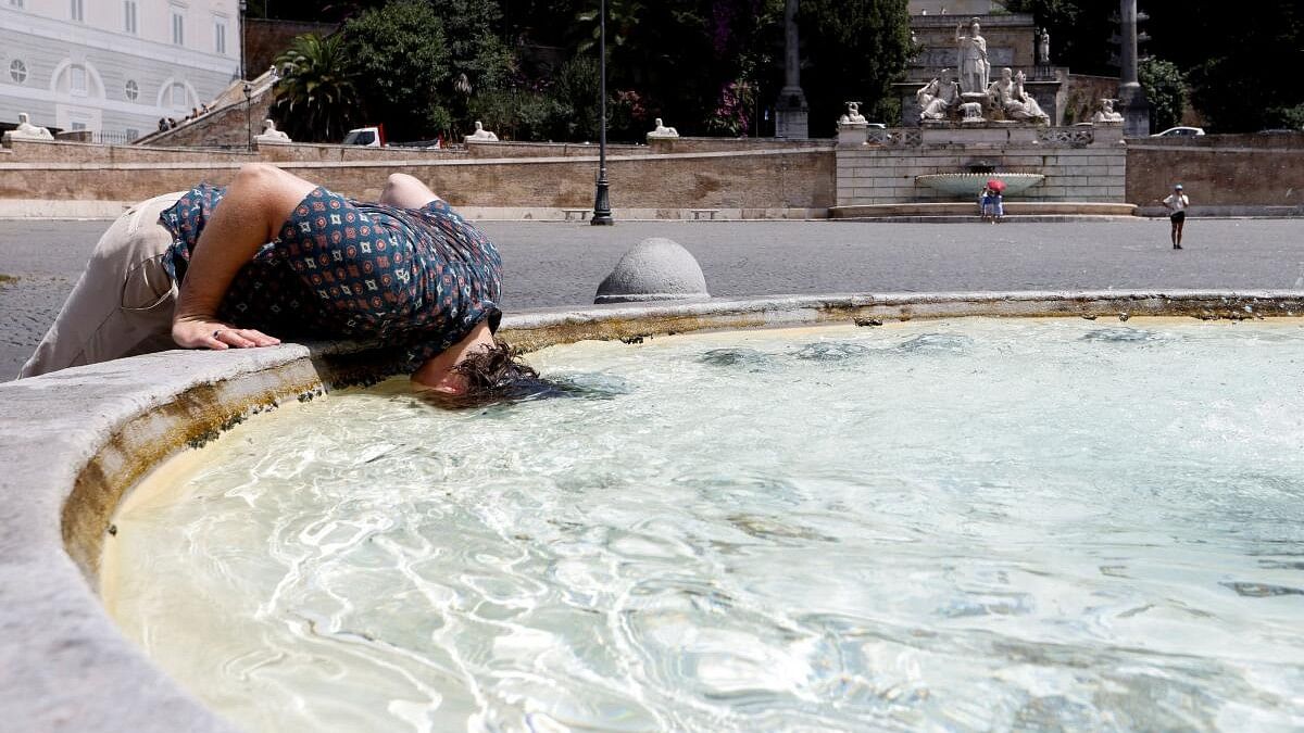 <div class="paragraphs"><p>A person cools off at the Piazza del Popolo, during a heatwave across Italy.</p></div>