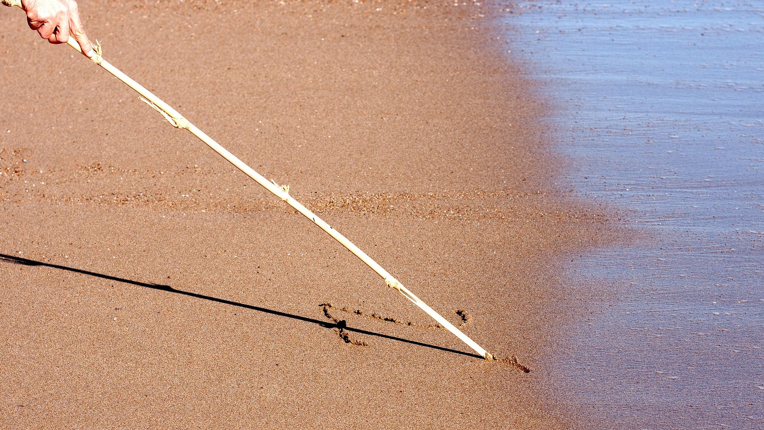 <div class="paragraphs"><p>Image of a man writing on wet soil with a stick (for representative purposes).</p></div>