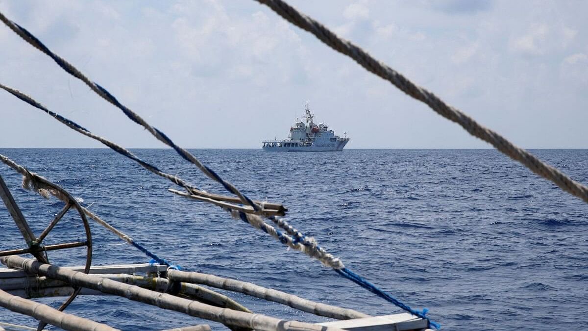 <div class="paragraphs"><p>A China Coast Guard ship is seen from a Philippine fishing boat at the disputed Scarborough Shoal.</p></div>