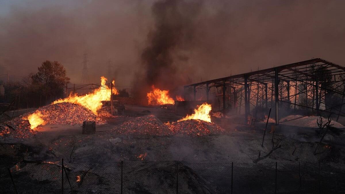 <div class="paragraphs"><p>Wildfire burns in Vrilissia, near Athens.</p></div>