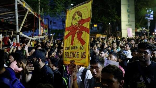 <div class="paragraphs"><p>A medical student carries a placard, as he walks along with doctors and paramedics to join a protest against the alleged rape and murder of a trainee doctor, inside the premises of R G Kar Medical College and Hospital in&nbsp;Kolkata.&nbsp;</p></div>