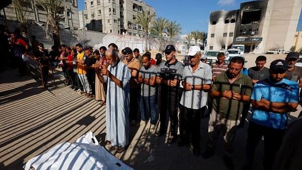 <div class="paragraphs"><p>Mourners pray near a body of a Palestinian killed in Israeli strike, amid Israel-Hamas conflict, at Nasser hospital in Khan Younis in the southern Gaza Strip, August 13, 2024. </p></div>