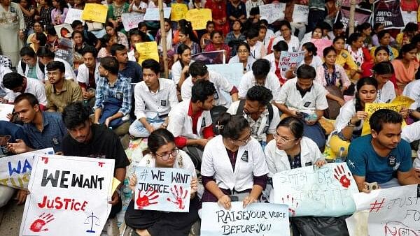 <div class="paragraphs"><p>Doctors and paramedics hold placards as they attend a protest against what they say is rape and murder of a trainee doctor, inside the premises of R G Kar Medical College and Hospital in Kolkata, India, August 12, 2024.</p></div>