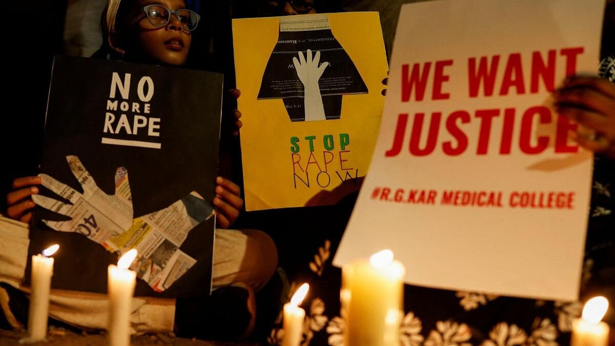 <div class="paragraphs"><p>People hold posters during a vigil condemning the rape and murder of a trainee medic at  Kolkata's R G Kar Hospital.</p></div>