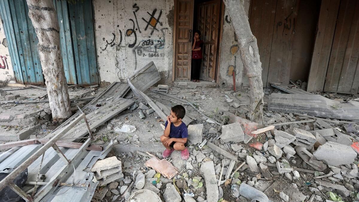 <div class="paragraphs"><p>A Palestinian boy sits at the site of an Israeli strike on a house, amid the Israel-Hamas conflict, in Maghazi refugee camp in the central Gaza Strip, August 14, 2024.</p></div>