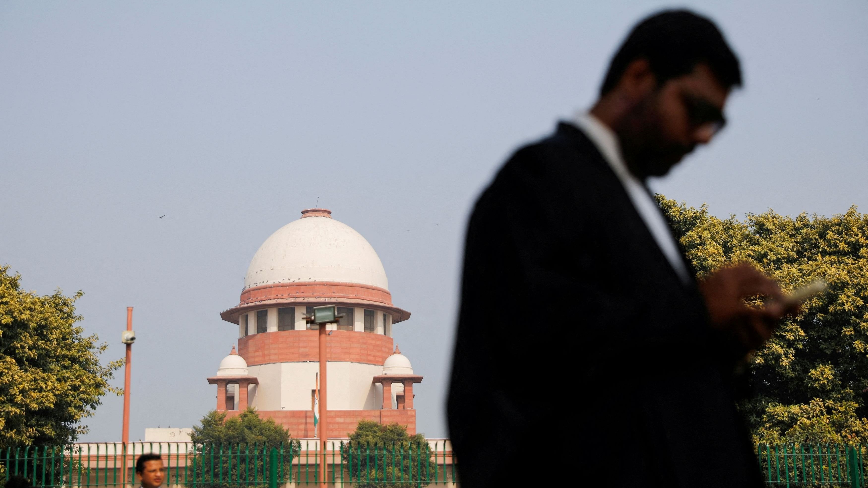 <div class="paragraphs"><p>A lawyer walks past the Supreme Court.</p></div>