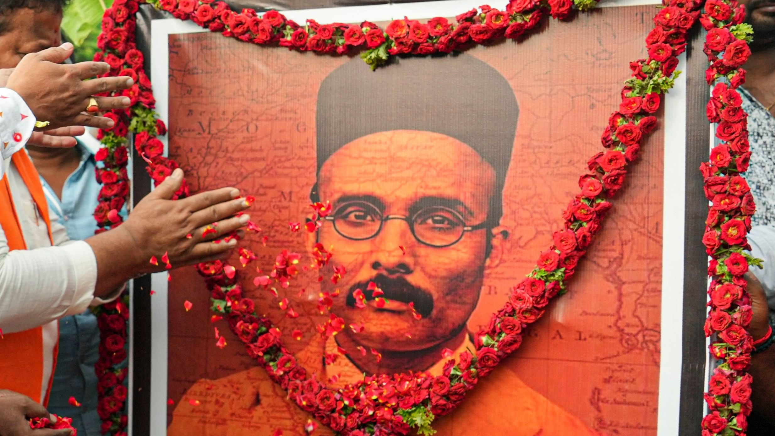 <div class="paragraphs"><p>A poster of V.D. Savarkar being garlanded. Representative image.</p></div>