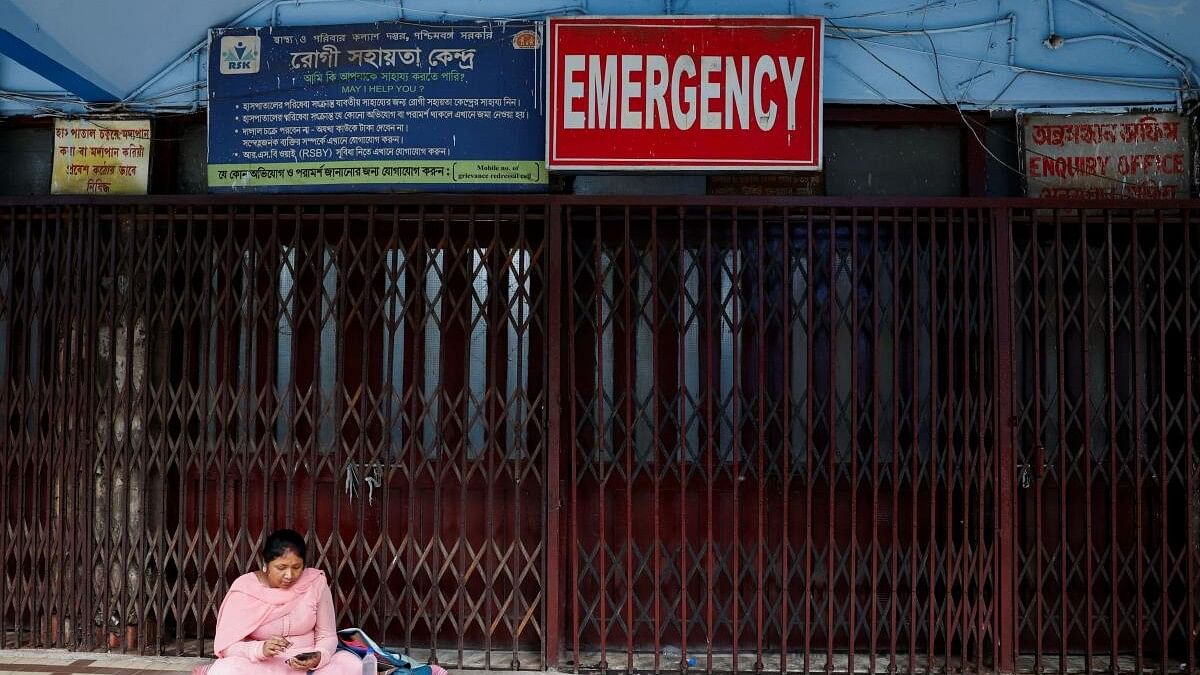 <div class="paragraphs"><p>A woman sits outside the medical emergency ward as medics protest against  rape and murder of a trainee doctor, inside the premises of R G Kar Medical College and Hospital.</p></div>