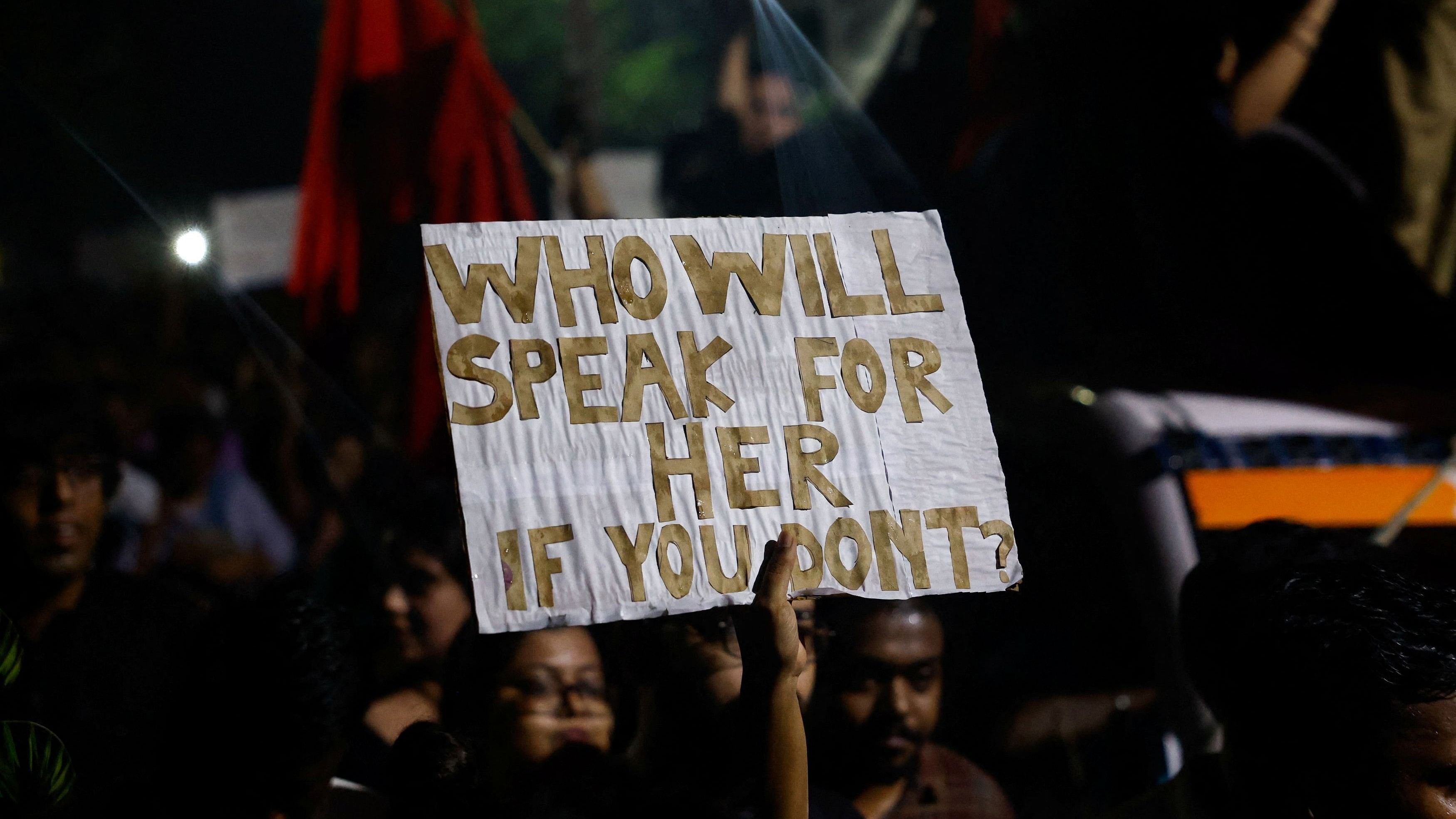 <div class="paragraphs"><p>A woman holds a placard as she attends a candlelight vigil held outside Jadavpur University campus, condemning the rape and murder of a trainee medic at a government-run hospital in Kolkata, India, August 15, 2024.</p></div>