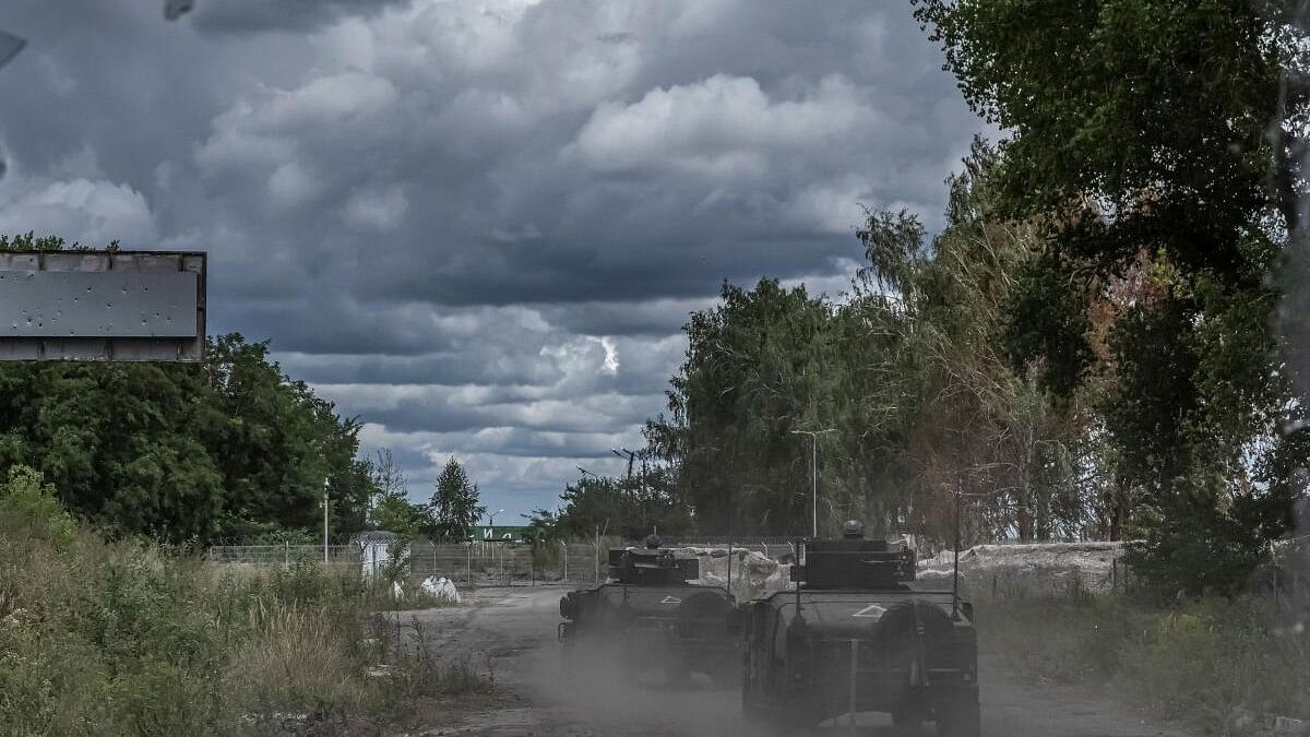 <div class="paragraphs"><p>Ukrainian soldiers ride military vehicles at a crossing point on the border with Russia, amid Russia's attack on Ukraine, in Sumy region.</p></div>