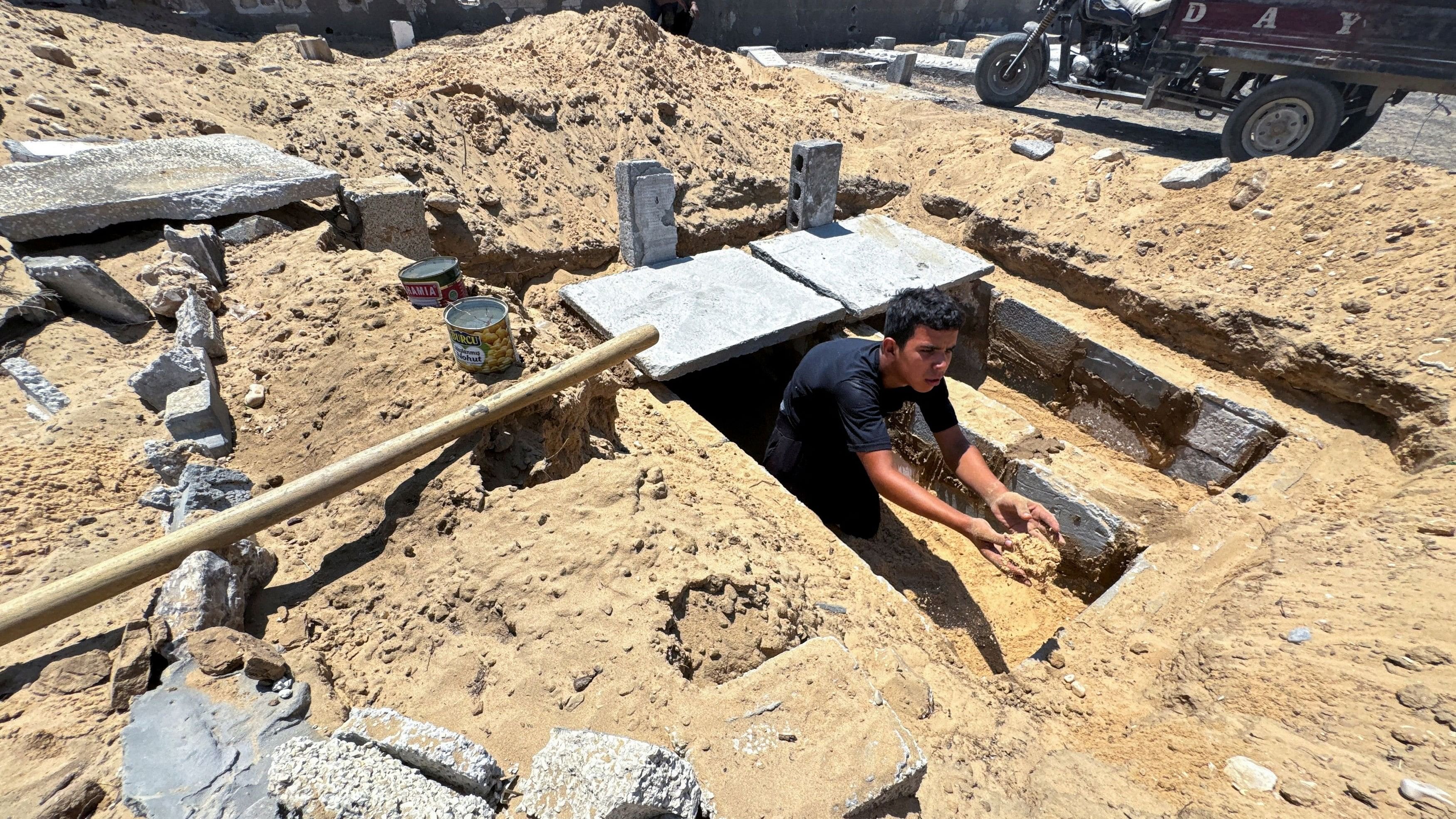 <div class="paragraphs"><p>A Palestinian prepares a grave in a cemetery as death toll surpasses 40,000, according to health ministry, amid Israel-Hamas conflict, in Khan Younis in the southern Gaza Strip.</p></div>