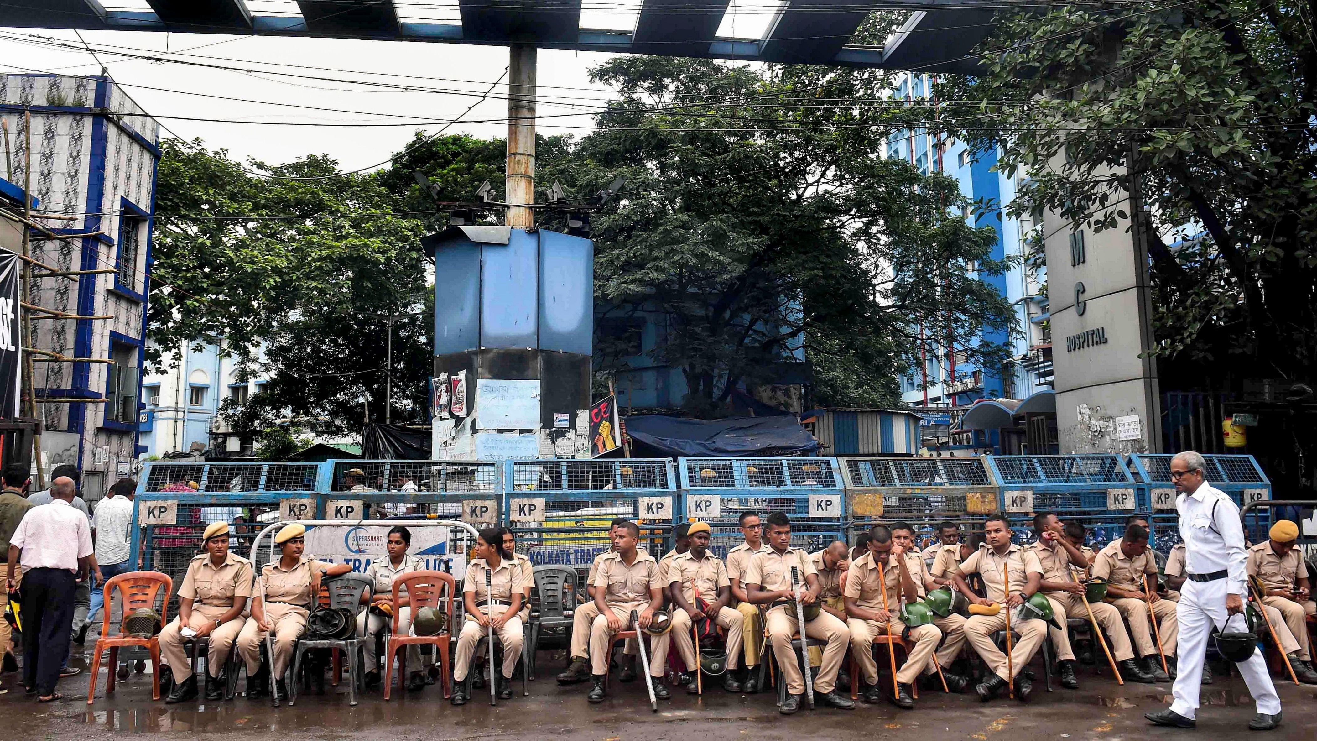 <div class="paragraphs"><p>Police personnel keep vigil as doctors protest against the alleged rape and murder of a woman doctor, at R G Kar Medical College and Hospital in Kolkata, Friday </p></div>