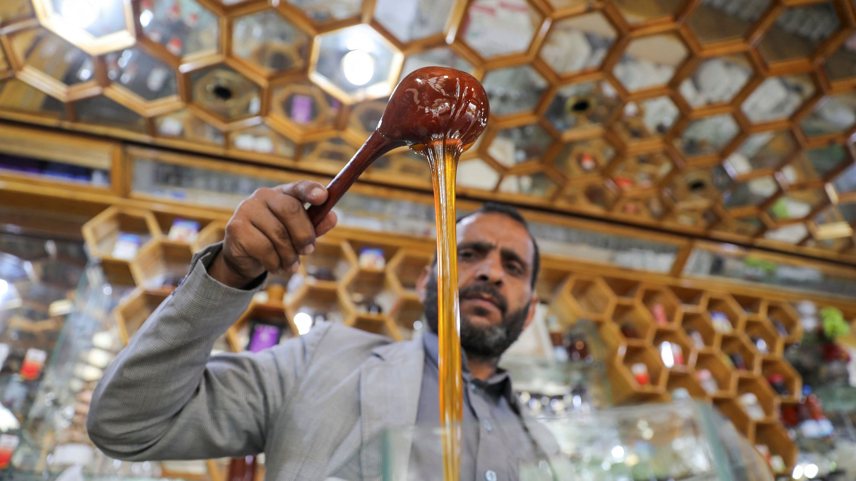 <div class="paragraphs"><p>A vendor pours honey at his shop. (Representative image)</p></div>