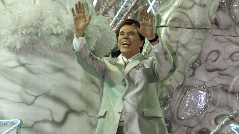 <div class="paragraphs"><p>File photo of&nbsp;Brazil's most famous TV personality and host of various game shows Silvio Santos waving to the crowd from atop his float for the 'Tradicao' samba school during a late-evening parade at the Sambadrome stadium in Rio de Janeiro.</p></div>