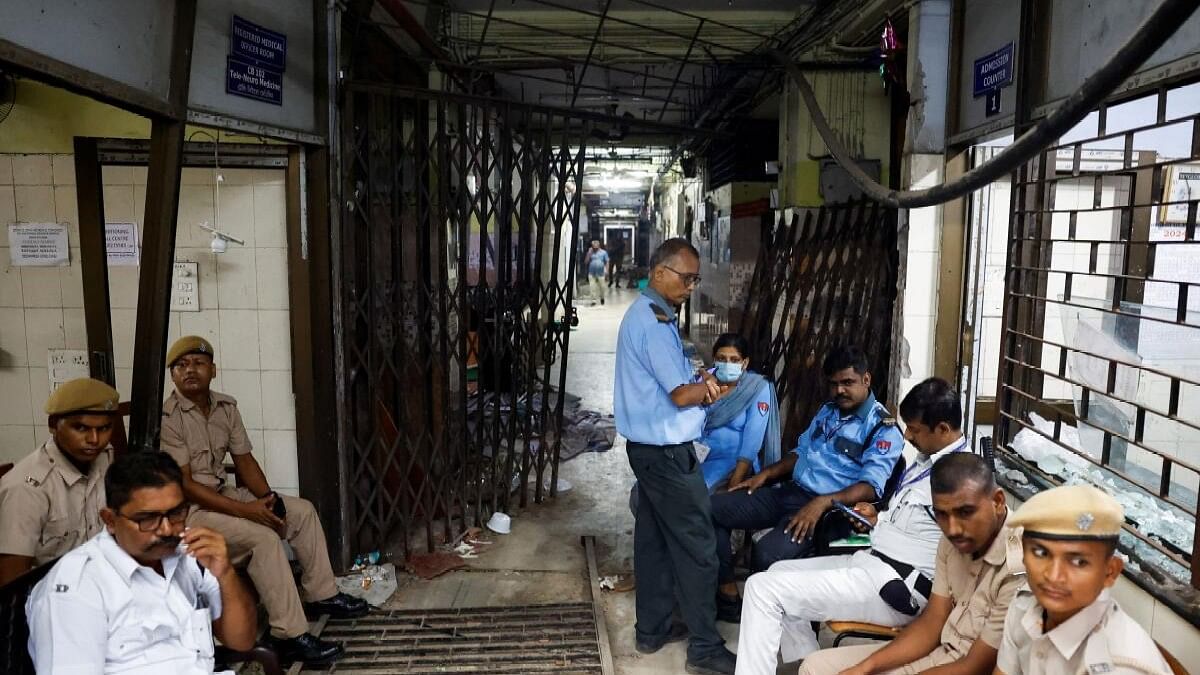 <div class="paragraphs"><p>Security officials sit at the entrance of the medical emergency ward that was vandalisedat Kolkata's R G kar hospital.&nbsp;</p></div>