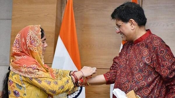 <div class="paragraphs"><p>A woman with CAA citizenship ties rakhi to Union Minister Piyush Goyal as he celebrates Rakshabandhan, in New Delhi, Monday, Aug. 19, 2024.</p></div>