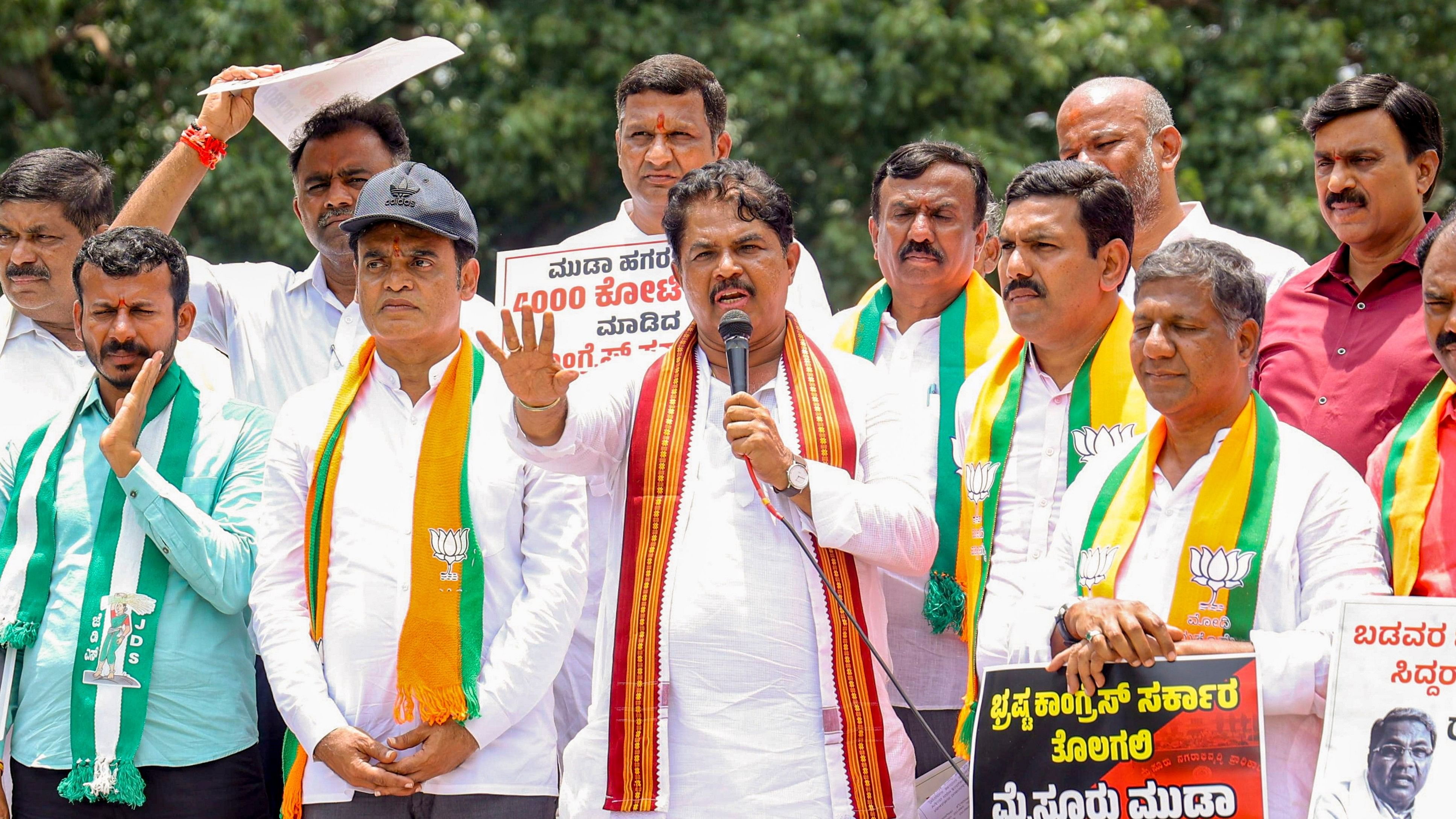 <div class="paragraphs"><p>Karnataka BJP President B.Y. Vijayendra with party leader R Ashoka and other during a protest against state Chief Minister Siddaramaiah over the alleged MUDA scam, near Mahatma Gandhi's statue at Vidhana Soudha, in Bengaluru, Monday, August 19, 2024. </p></div>