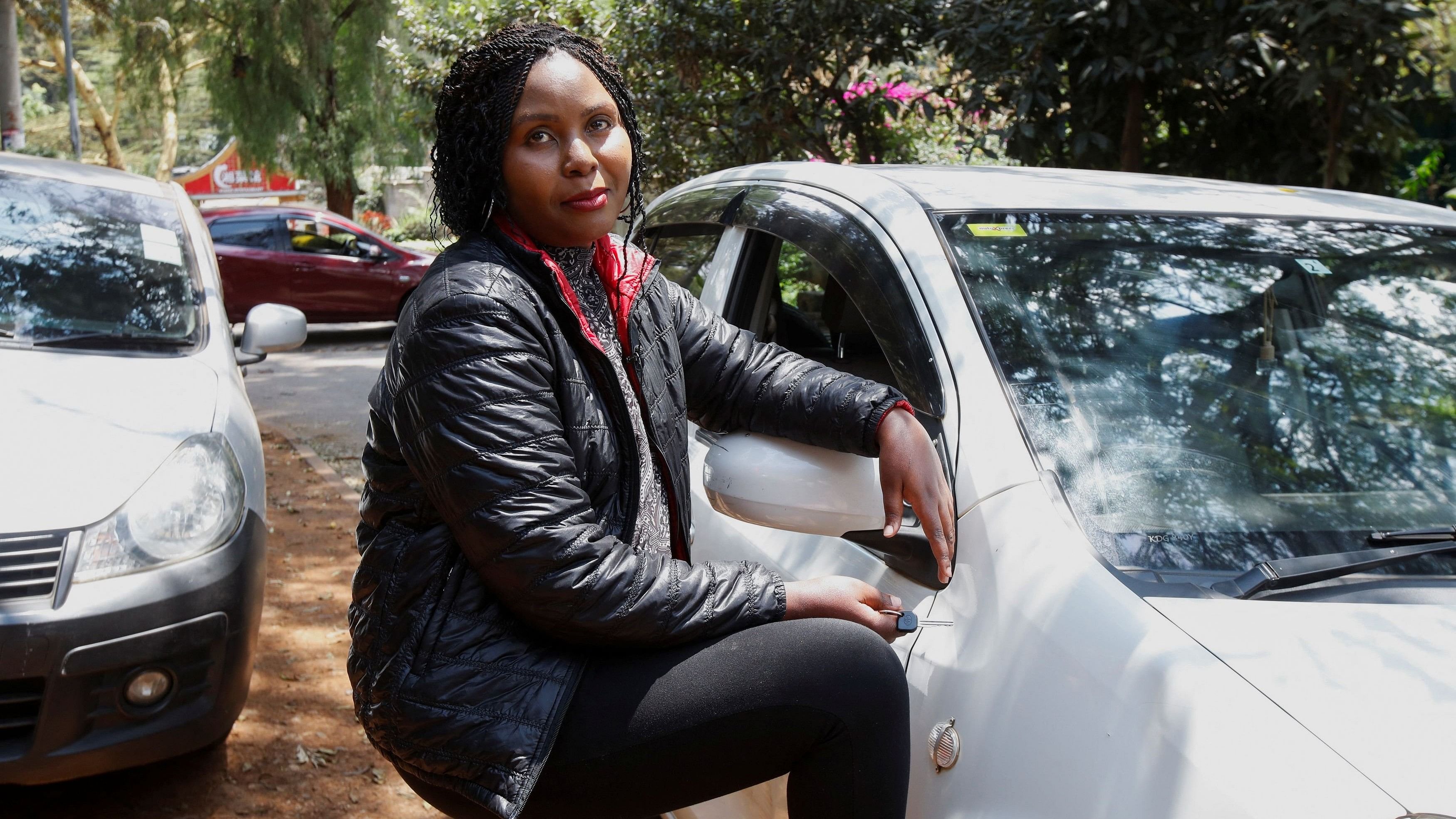 <div class="paragraphs"><p>Kenyan taxi driver Judith Chepkwony looks on, outside her vehicle during a Reuters interview about reduced fares, in Nairobi, Kenya, August 14, 2024.</p></div>