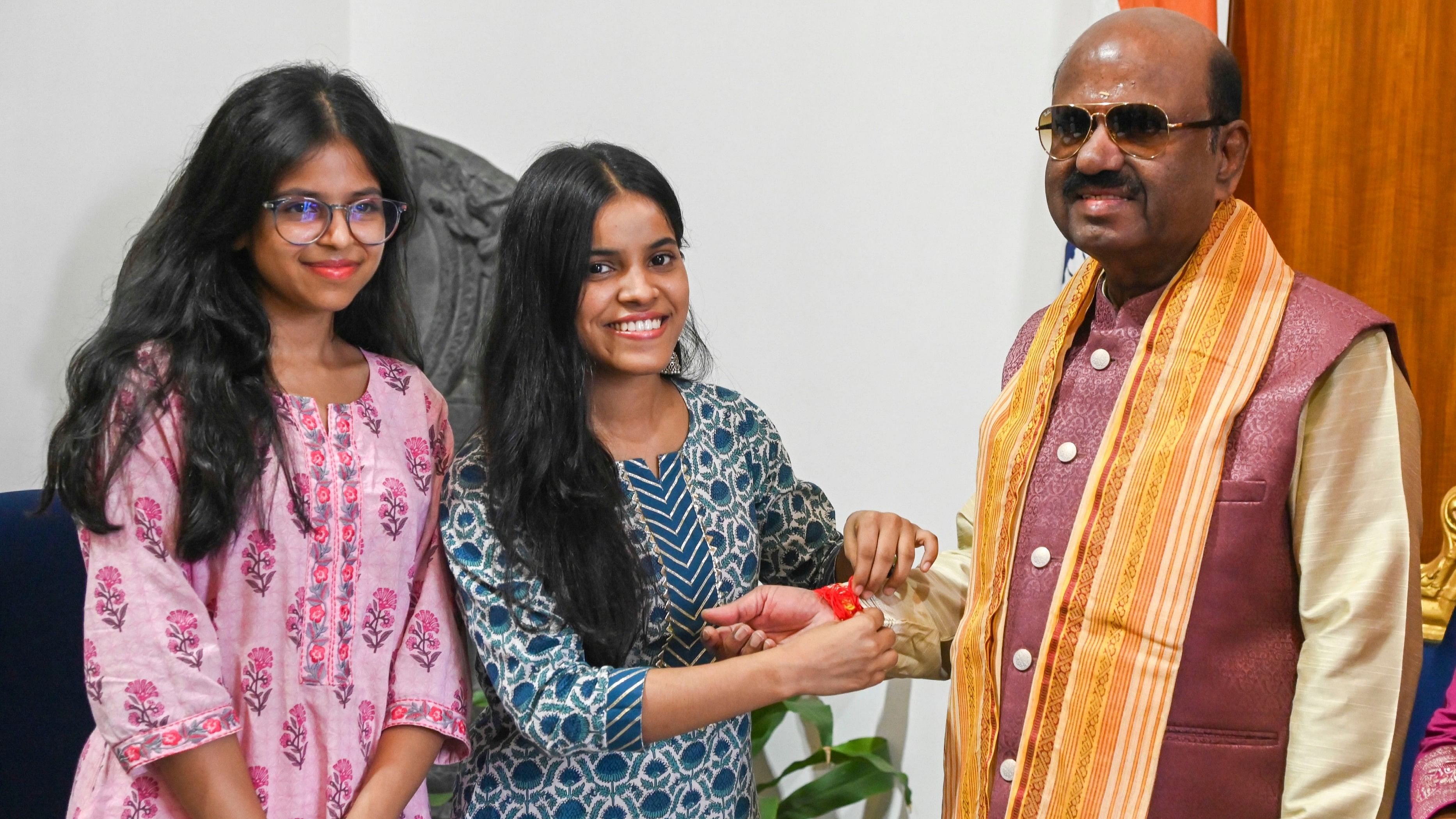 <div class="paragraphs"><p>Medical students tie 'rakhi' to the wrist of West Bengal Governor CV Ananda Bose during Raksha Bandhan festival, at Raj Bhavan in Kolkata, Monday, Aug. 19, 2024.</p></div>