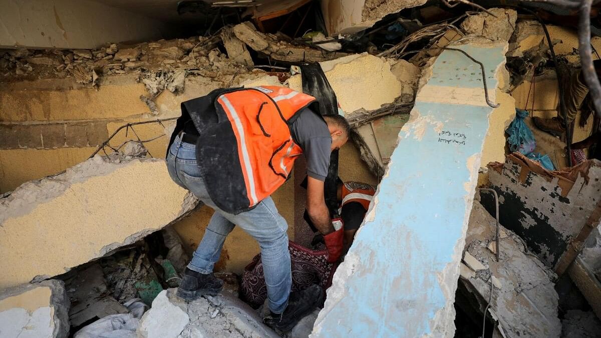 <div class="paragraphs"><p>Members of civil defense work to recover bodies of Palestinians killed in an Israeli strike on a school sheltering displaced people, amid the Israel-Hamas conflict, in Gaza.</p></div>