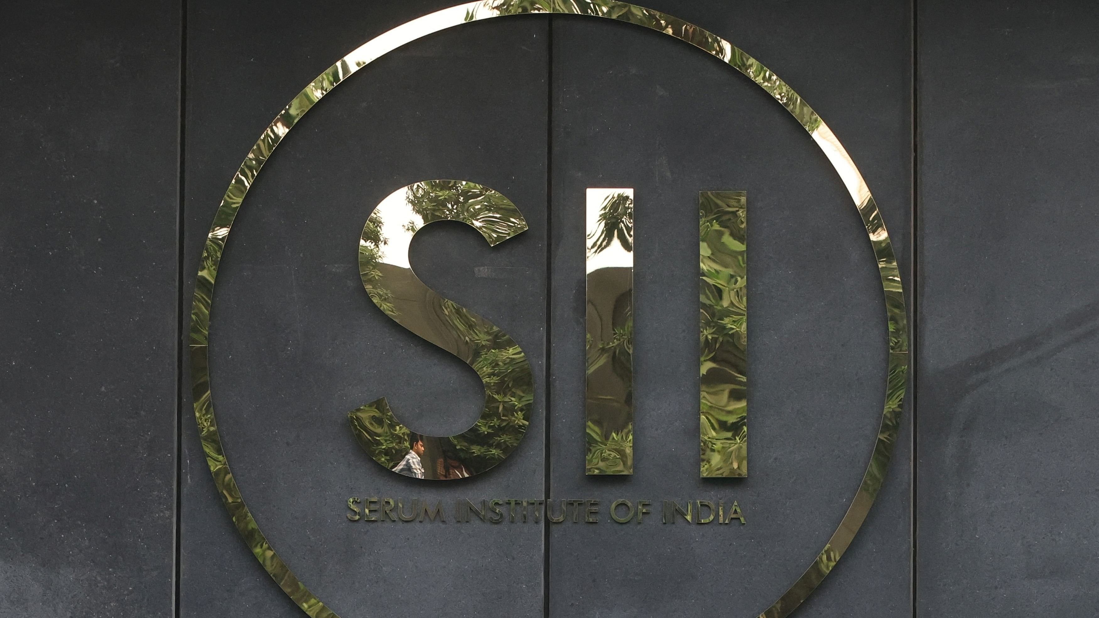 <div class="paragraphs"><p>A man's reflection is seen in the logo of the Serum Institute of India, inside the facility in Pune, India.</p></div>