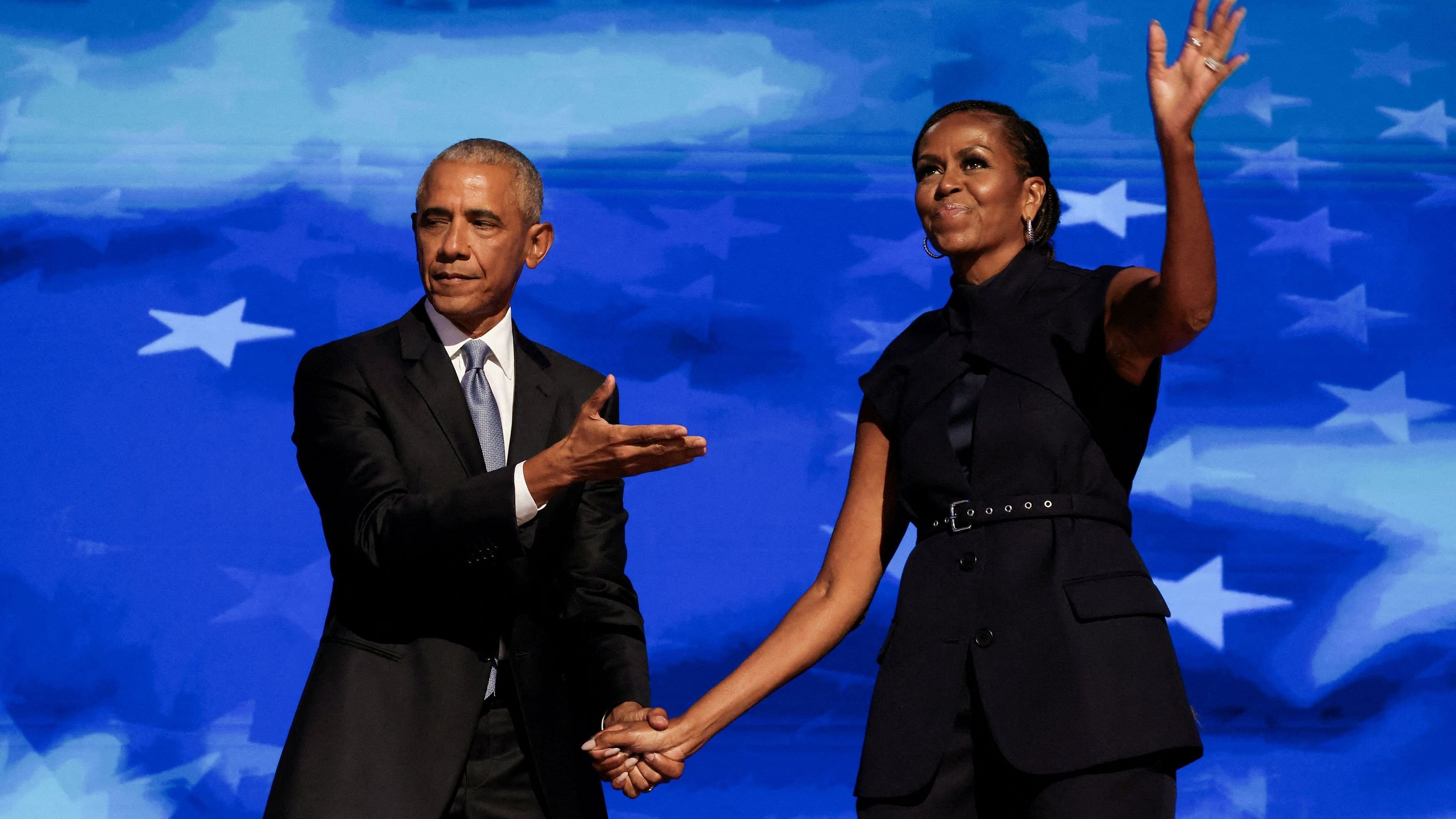 <div class="paragraphs"><p>Former US first lady Michelle Obama greets her husband, former US President Barack Obama, on stage during Day 2 of the Democratic National Convention  in Chicago, Illinois, U.S., August 20, 2024. </p></div>