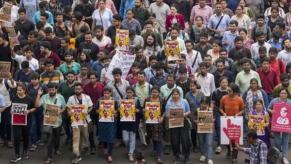 <div class="paragraphs"><p>Doctors raise slogans during a protest rally over the recent alleged rape and murder of a trainee doctor at the RG Kar Medical College and Hospital, in Kolkata, Wednesday, August 21, 2024. </p></div>