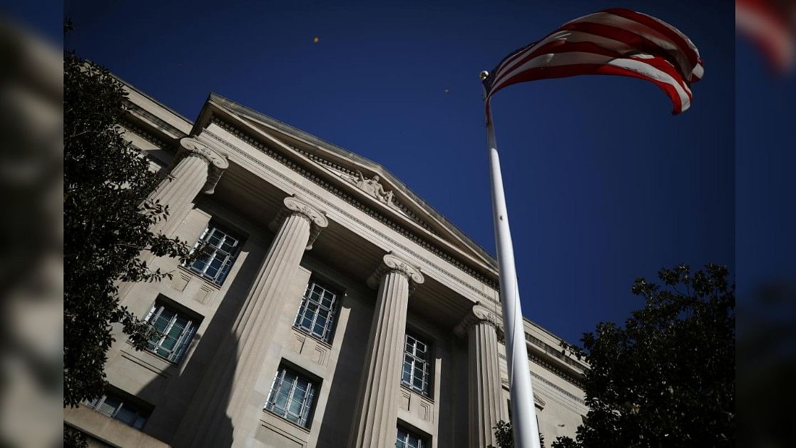 <div class="paragraphs"><p>American flag waves outside the US Department of Justice Building in Washington.</p></div>