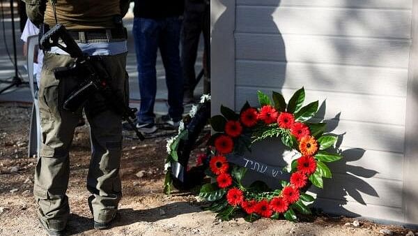 <div class="paragraphs"><p>An Israeli soldier stands next to tributes during the funeral of Yoram Metzger, one of the six hostages whose bodies were retrieved from Gazan captivity and brought to Israel in a military operation, in Kibbutz Nir Oz, southern Israel, August 22, 2024. </p></div>