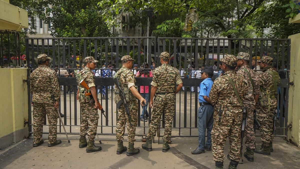 <div class="paragraphs"><p>Seurity personnel stand guard at Central Government Offices (CGO) complex, housing the CBI office, in Kolkata.</p></div>