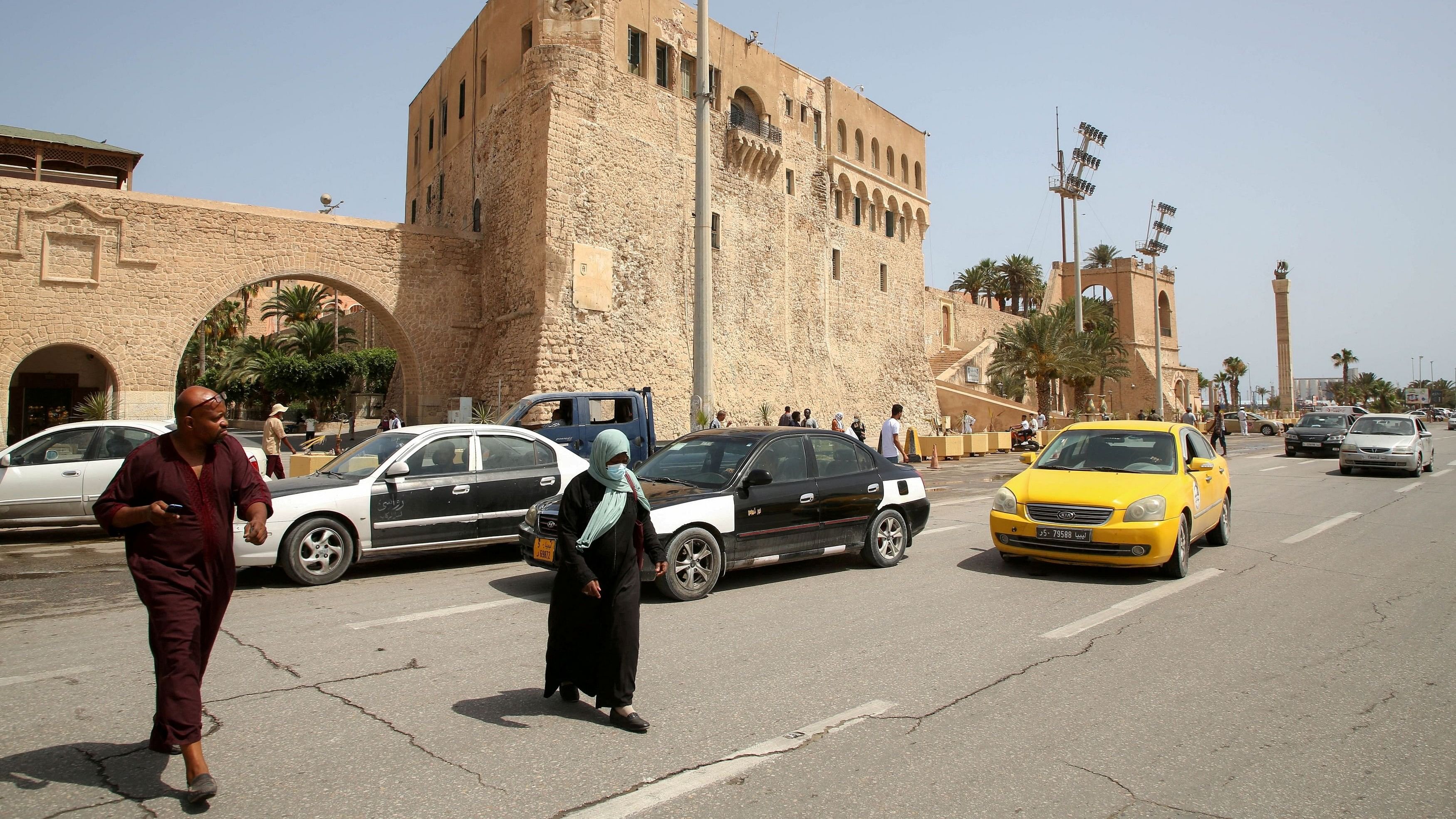 <div class="paragraphs"><p>People cross a street at Martyrs Square in Tripoli, Libya.</p></div>