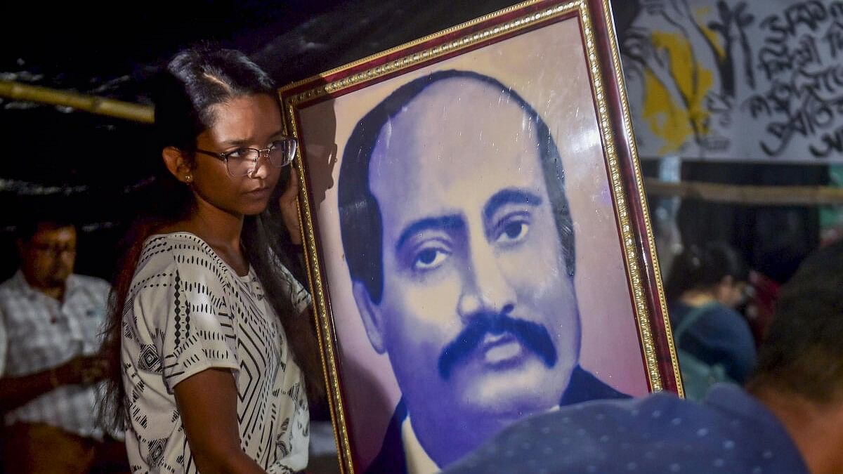 <div class="paragraphs"><p>A doctor holds a portrait of Radha Gobinda Kar, founder of the RG Kar Medical College and Hospital, on his birth anniversary, during a protest against the alleged rape and murder of a trainee woman doctor inside the hospital, in Kolkata.&nbsp;</p></div>