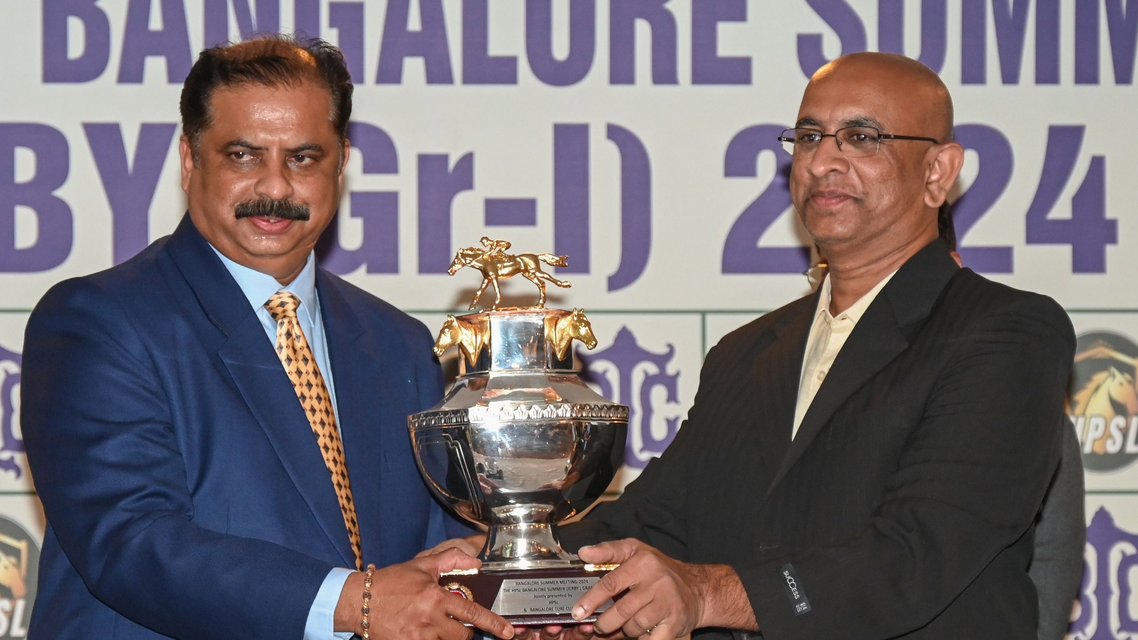 <div class="paragraphs"><p>VSN Raju (right), Director (Event) of HPSL Sports and Leisure Pvt Ltd, and Aravind Katarki, steward of Bangalore Turf Club, unveil the HPSL Bangalore Summer Derby (Gr-I) trophy on Thursday. </p></div>