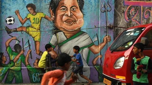 <div class="paragraphs"><p>Children play in front of Mamata Banerjee wall graffiti in Kolkata. Representative image.</p></div>