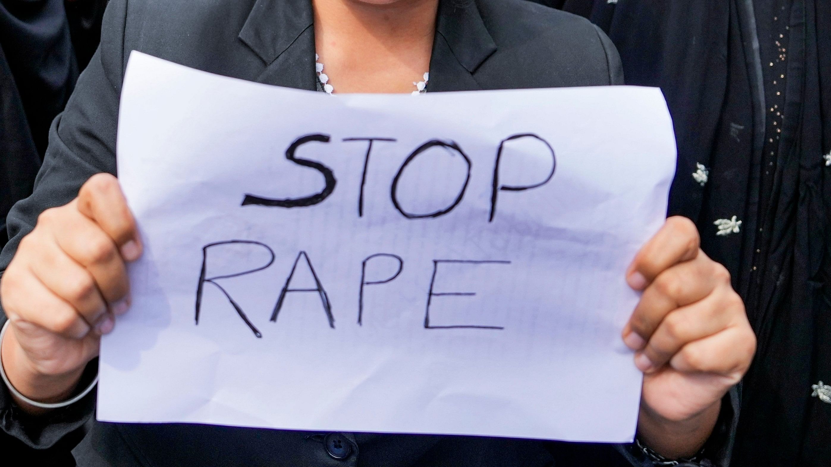 <div class="paragraphs"><p>A member of the legal community holds a poster during a protest march against the alleged sexual assault and murder of a postgraduate trainee doctor in Kolkata.</p></div>