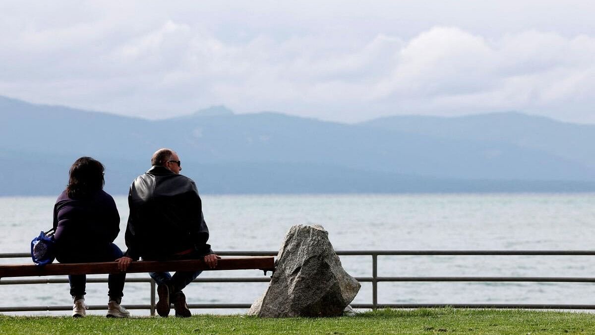 <div class="paragraphs"><p>A couple looks out over Lake Tahoe as an unusual summer cold front approaches in South Lake Tahoe, California, US.<br></p></div>