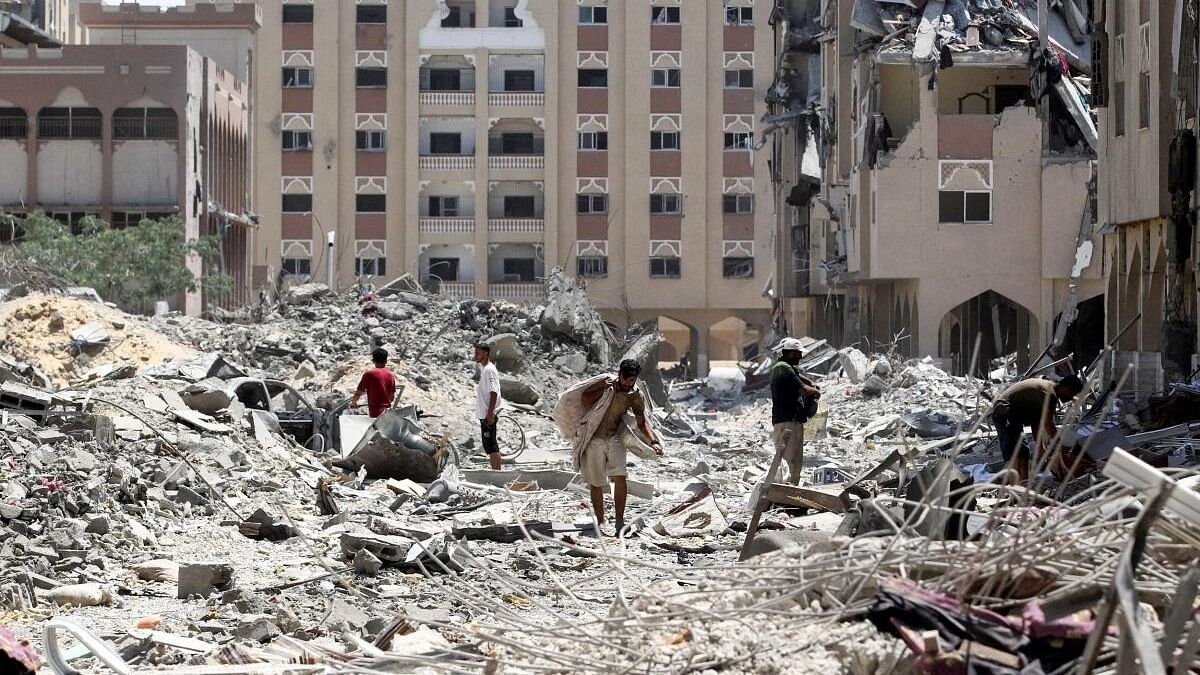 <div class="paragraphs"><p>Palestinians inspect damage following an Israeli raid.</p></div>