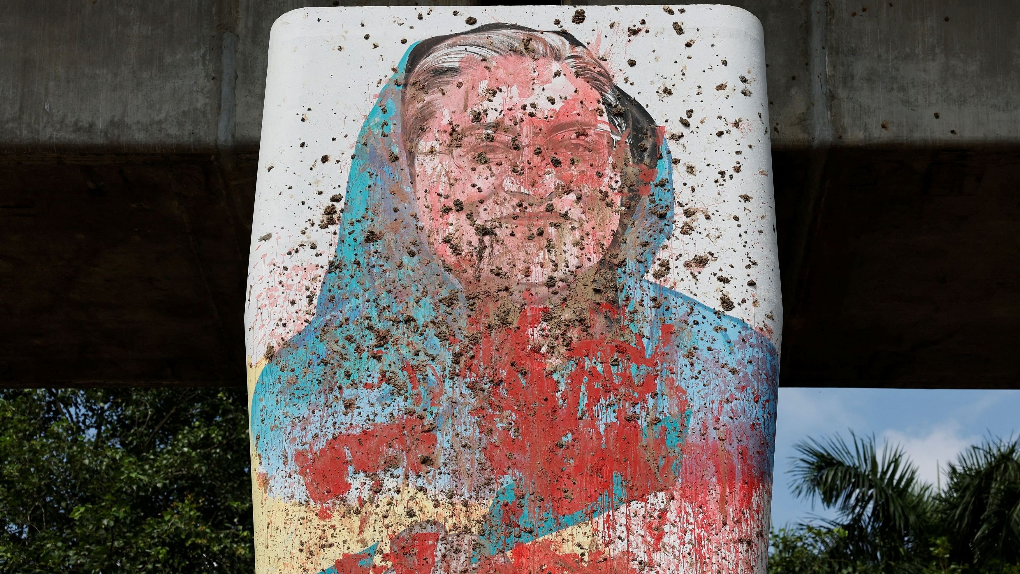 <div class="paragraphs"><p>A mural of Bangladeshi Ex Prime Minister Sheikh Hasina is seen vandalised by protesters </p></div>