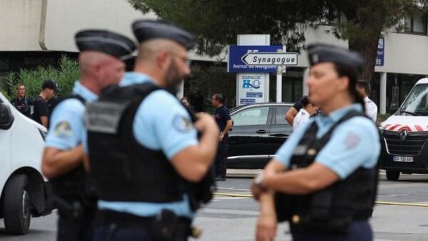 <div class="paragraphs"><p>French police stand guard after cars were set on fire in front of the city's synagogue, in La Grande-Motte.</p></div>