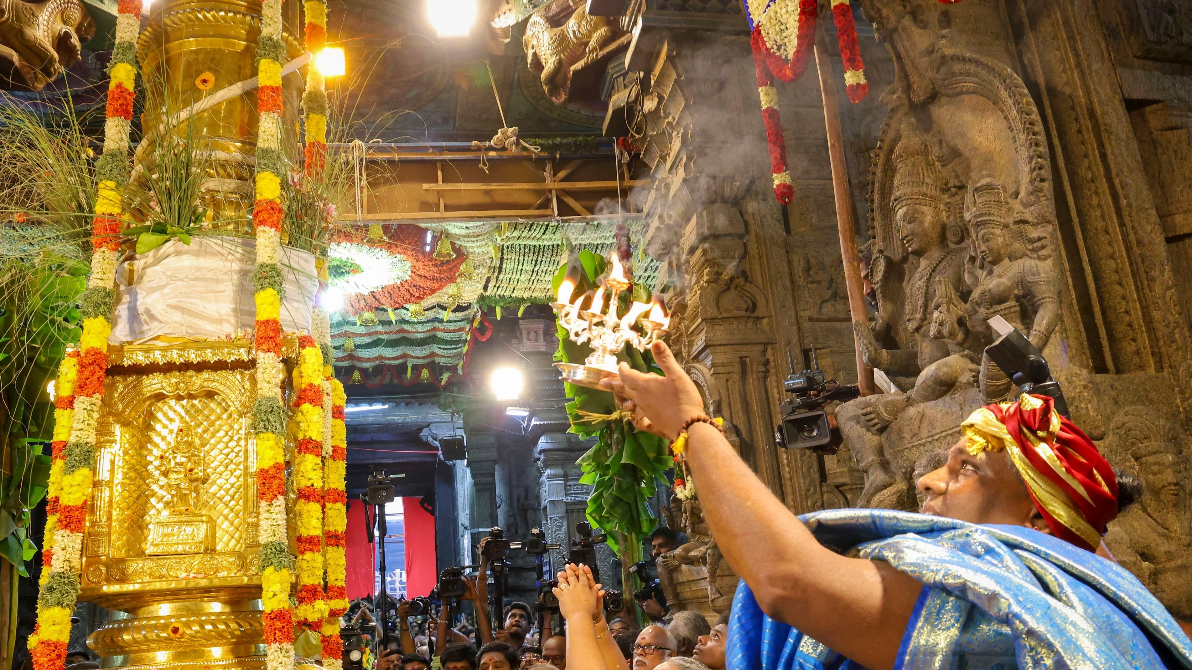 <div class="paragraphs"><p>A priest performs prayers at the Meenakshi Amman templein Madurai.</p></div>