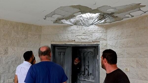 <div class="paragraphs"><p>People look at the damage at a residential building following a direct-hit from a projectile, after Hezbollah launched hundreds of rockets and drones towards Israel in what the Iranian-backed movement said was a response to the assassination of a senior commander in Beirut last month, in northern Israel August 25, 2024. </p></div>