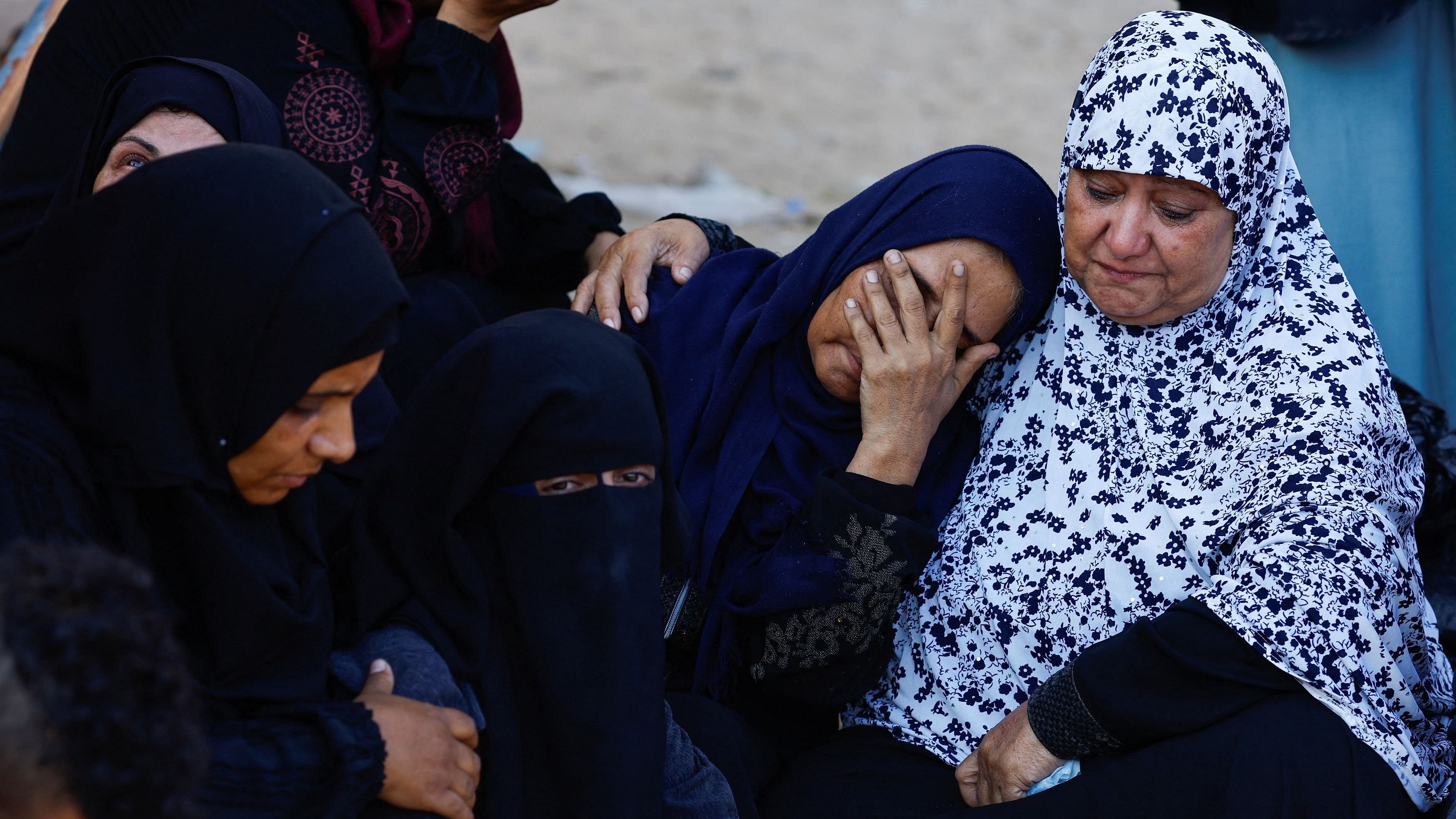 <div class="paragraphs"><p>Mourners react during the funeral of Palestinians killed in Israeli strikes.</p></div>