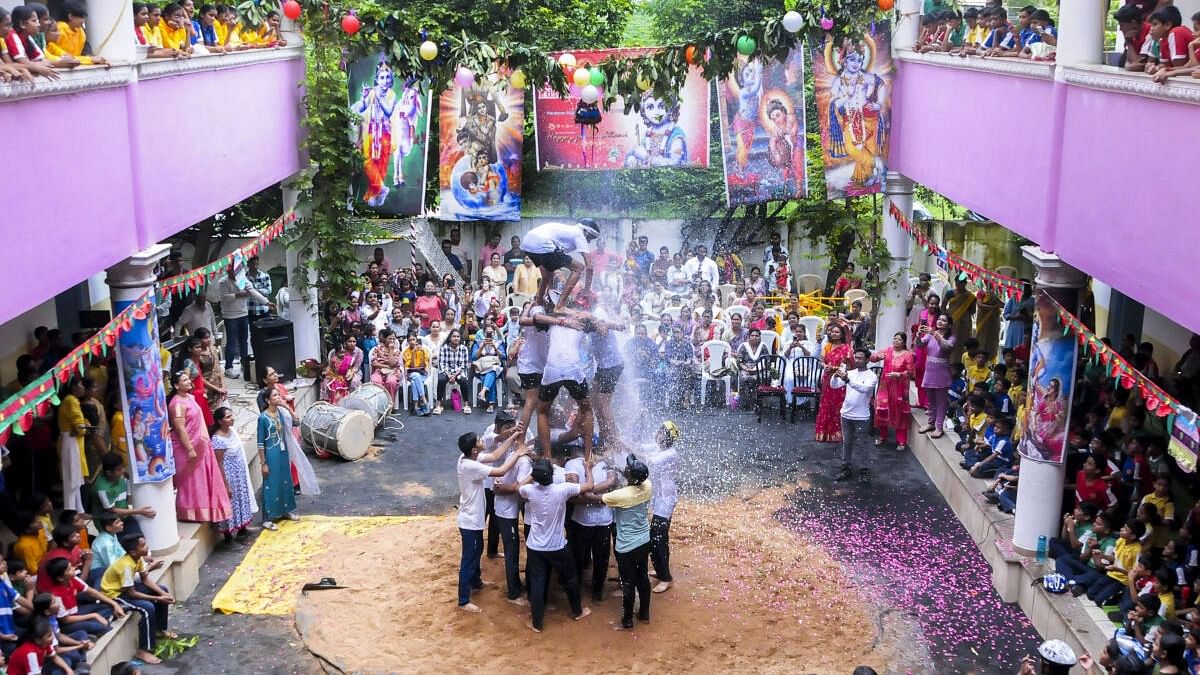 <div class="paragraphs"><p>School students form a pyramid as they attempt to break a 'Dahi Handi' during 'Janmashtami' celebrations.</p></div>