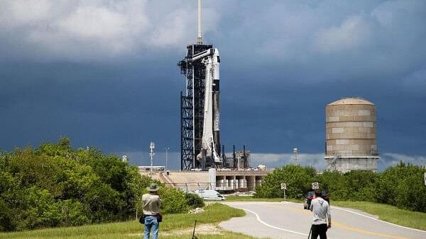 <div class="paragraphs"><p>A SpaceX Falcon 9 rocket is prepared for launch of Polaris Dawn, a private human spaceflight mission, as photographers look on at the Kennedy Space Center in Cape Canaveral, Florida, US August 26, 2024. Two crew members are expected to attempt the first-ever private spacewalk.</p></div>