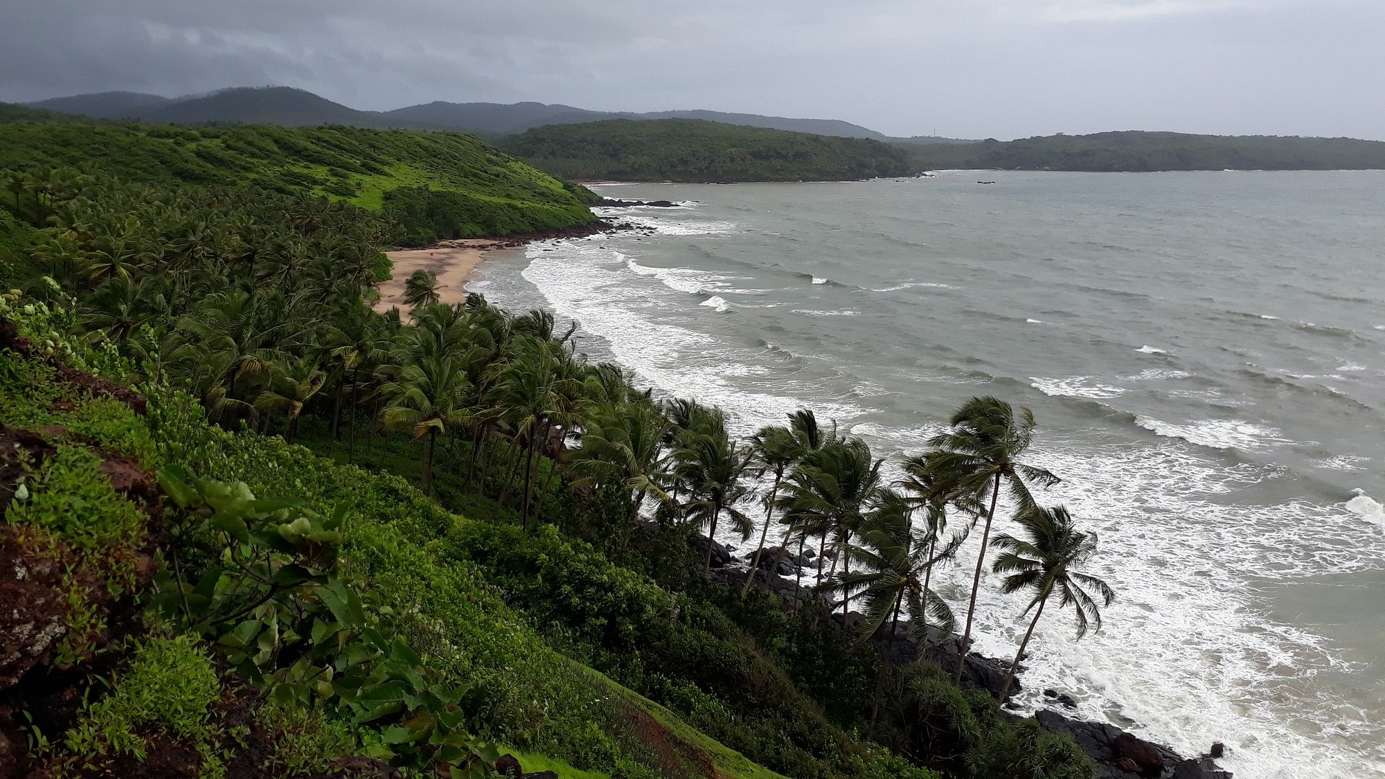 <div class="paragraphs"><p>Aerial view of a beach in Goa with hills visible in the backdrop</p></div>